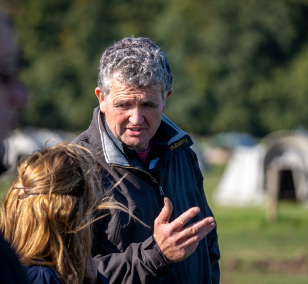 Two people chatting in a field