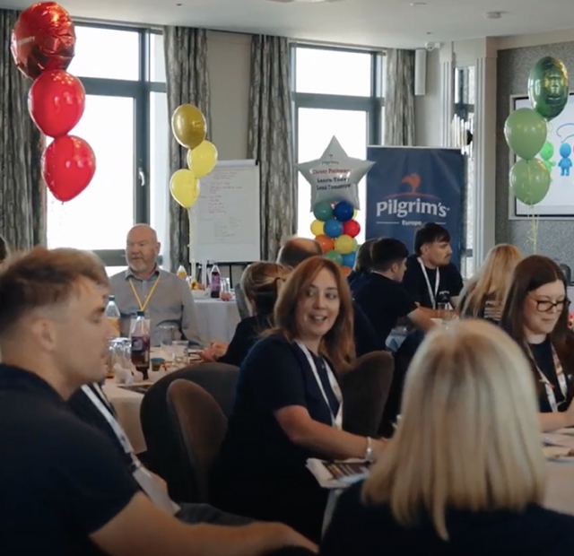 People in a room celebrating with balloons and food